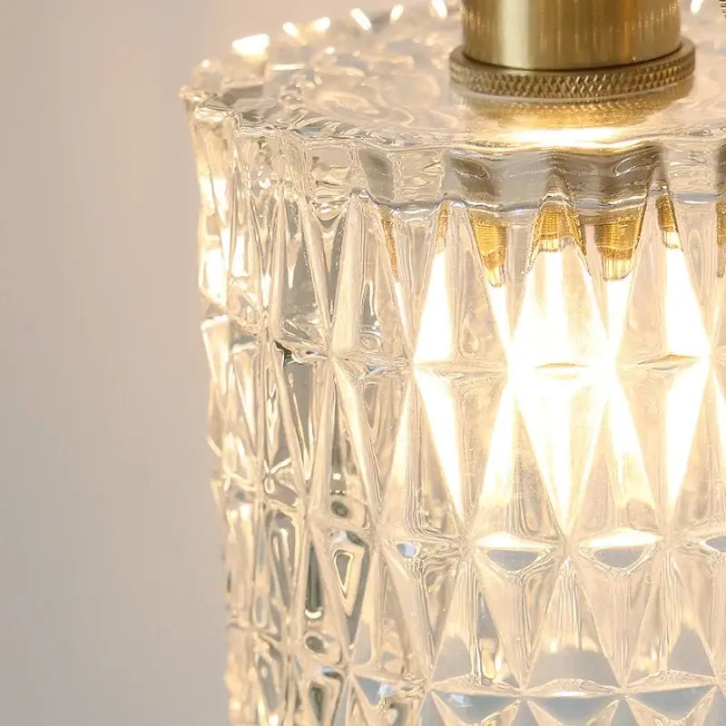 Modern brass e27 led wall sconce featuring clear glass shade with faceted diamond-cut design and brass finish top