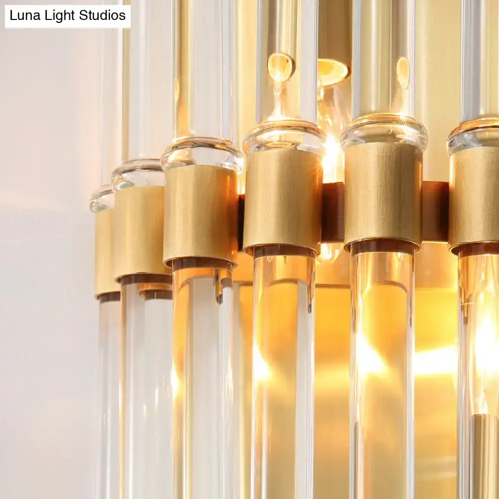 Modern brass finish clear crystal sconce lamp with gold-toned chandelier and glass tubes for bedroom lighting