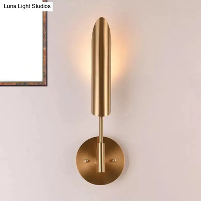 Modern brass finish led wall lamp with a sleek cylindrical shade and circular base for bedroom 220v-240v 110v-120v use