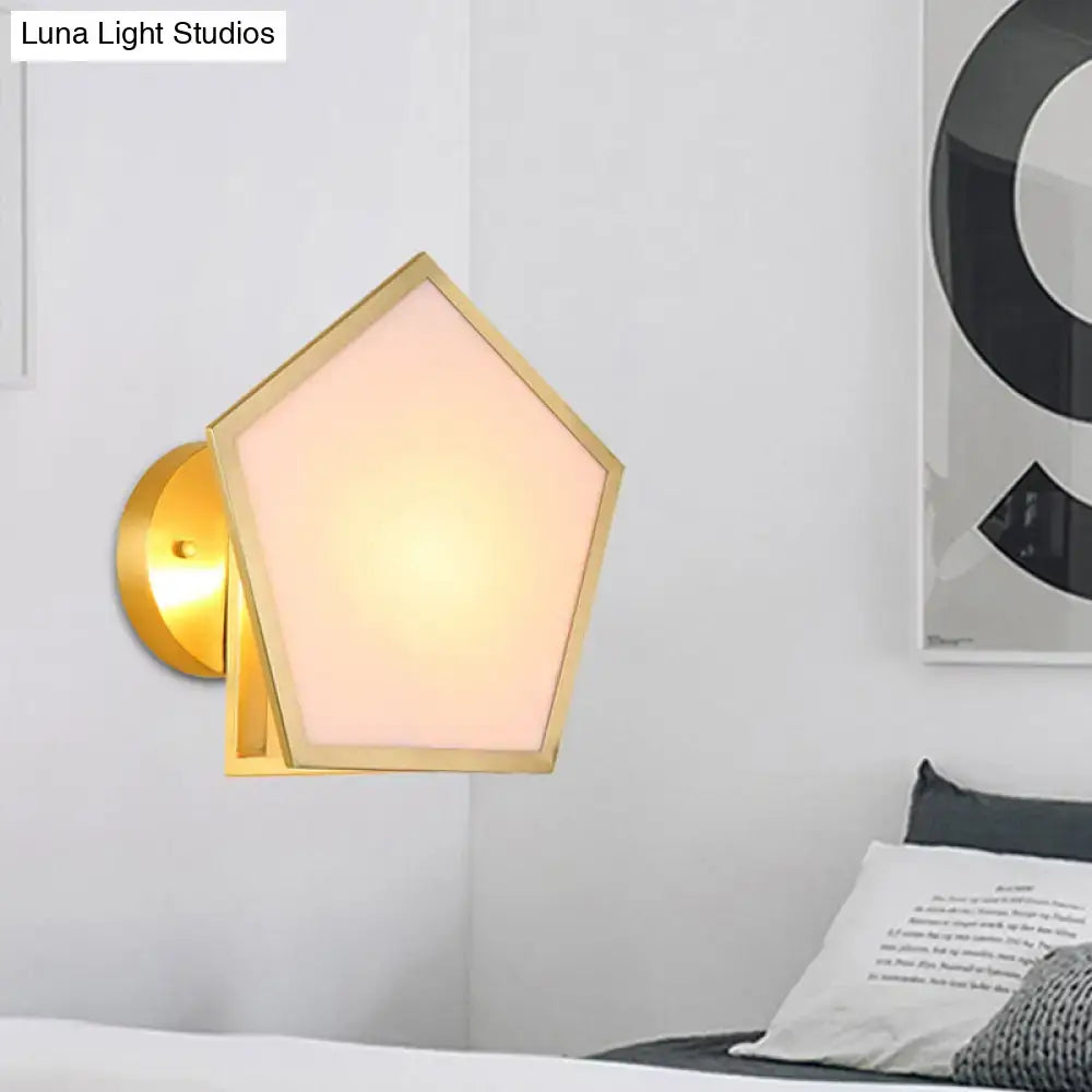 Modern brass finish pentagon wall lamp with gold-finished metal and warm-toned pink translucent glass shade