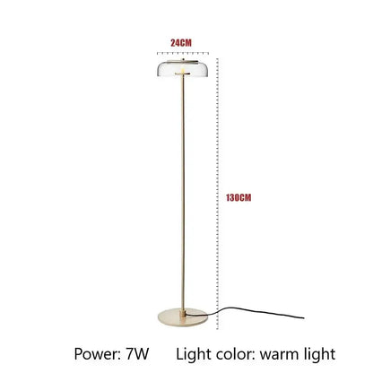 Modern brass floor lamp with slender gold-toned stand and glass lampshade ideal for living room decorbites circular glass