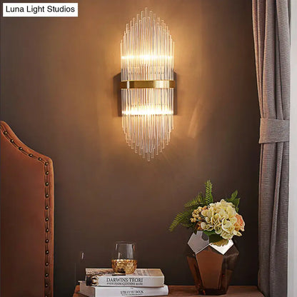 Modern brass wall sconce with fluted glass shade and gold-toned metal accents direct wired electric bedroom light