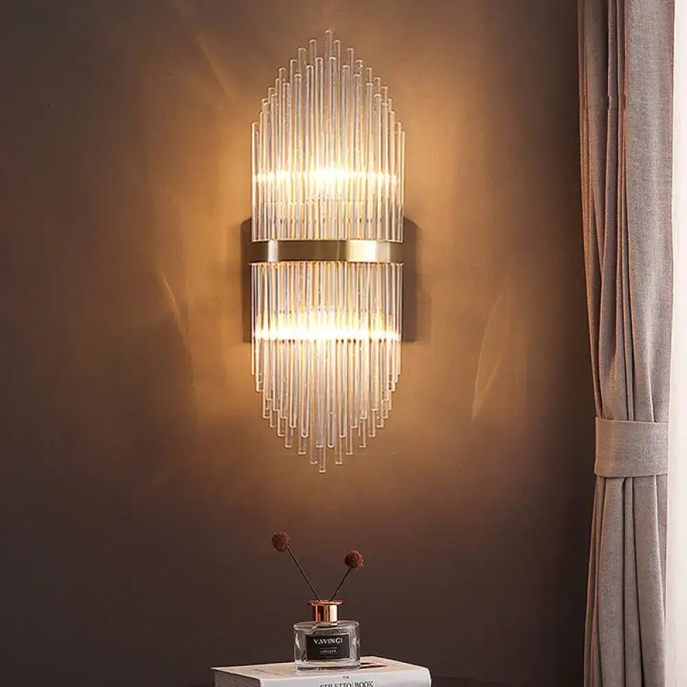 Modern brass fluted glass shade wall sconce with clear glass tubes and polished brass bands for direct wired electric use