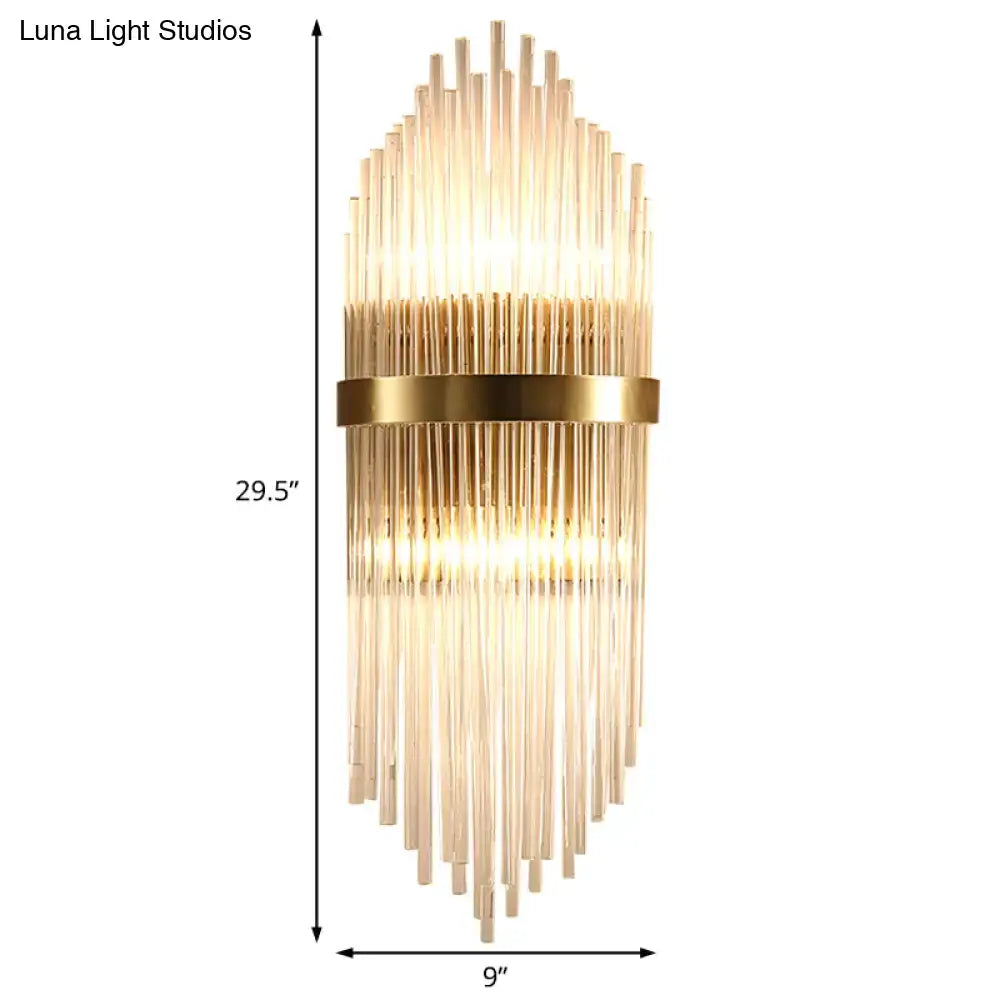 Gold-toned modern brass wall sconce with fluted glass shade and direct wired electric design for bedroom lighting