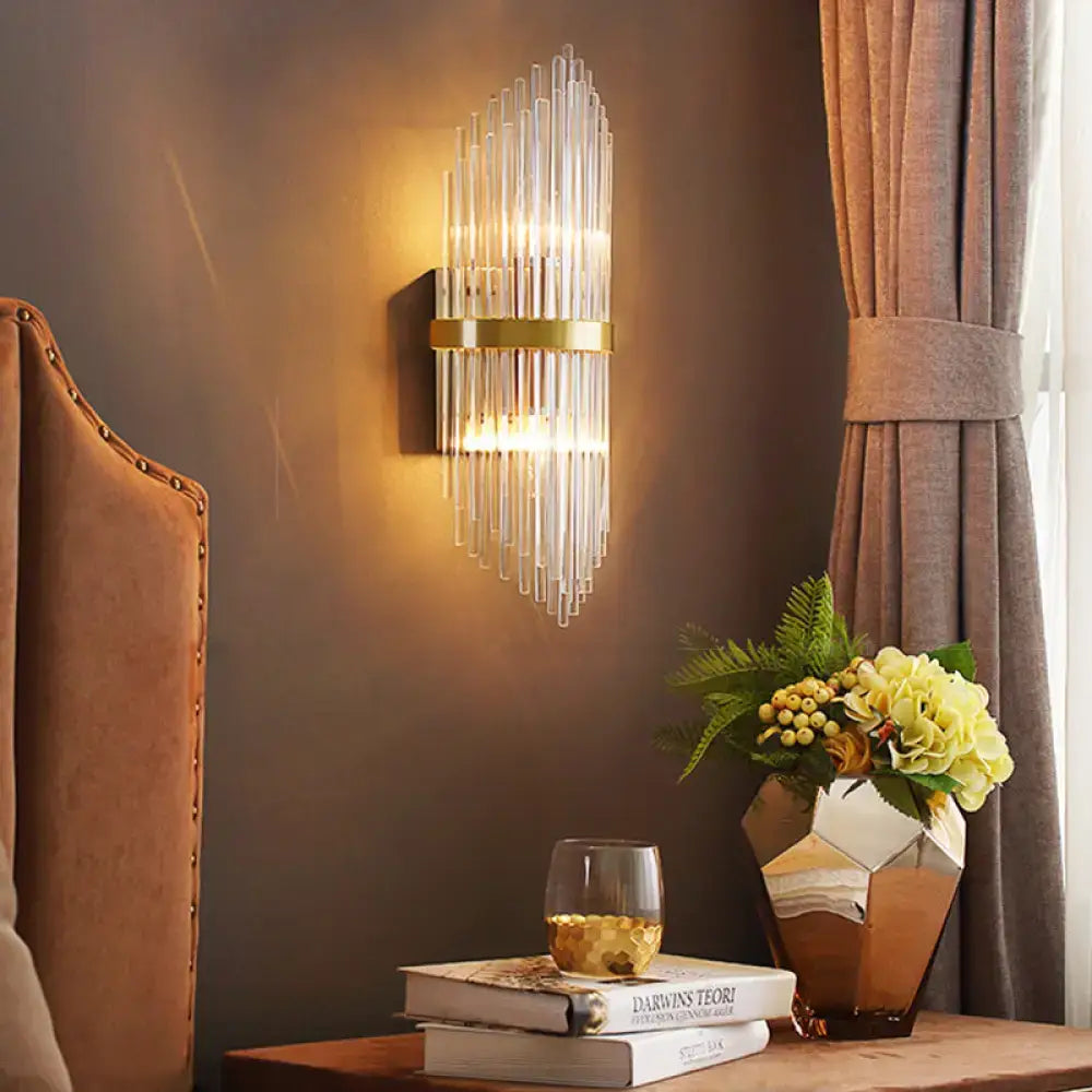 Modern brass wall sconce with fluted glass shade and gold-toned metal frame direct wired electric bedroom light