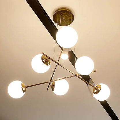 Modern brass french glass ball pendant light with six glowing white spherical shades for dining room decorbites french glass