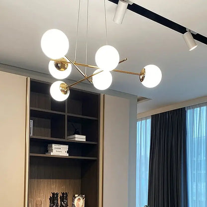 Modern brass pendant light with five white decorbites french glass ball globes for dining room decor