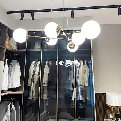 Modern brass pendant light with multiple spherical white decorbites french glass ball globes for dining room decor