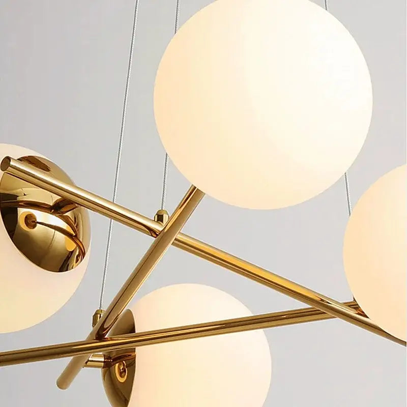 Modern brass french glass ball pendant light with gold-toned metal and frosted globe shades for dining room decorbites french glass