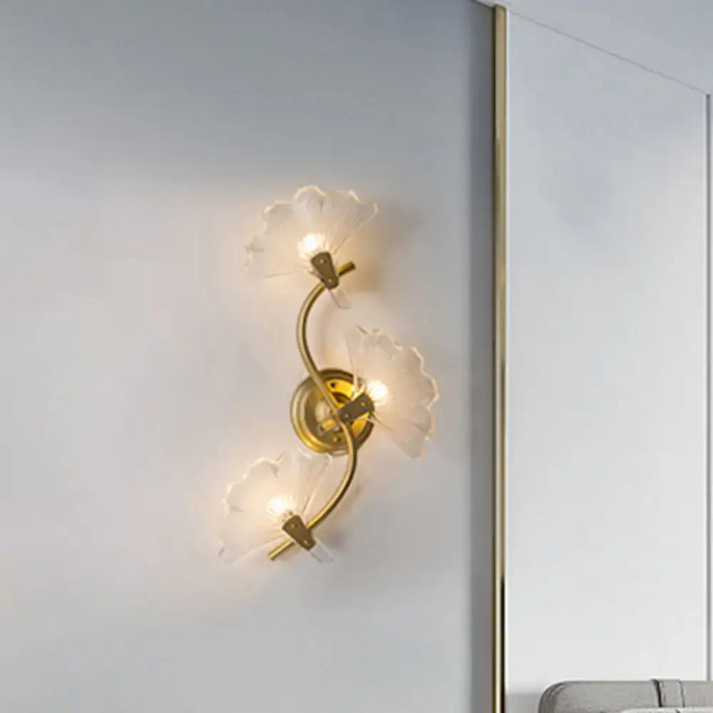 Modern brass ginkgo leaves wall light with gold-toned metal and three translucent petal-shaped glass shades for bedroom use