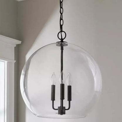 Black metal ball led chandelier with clear glass globe and three candle-style bulbs for dining room decorbites glass ball
