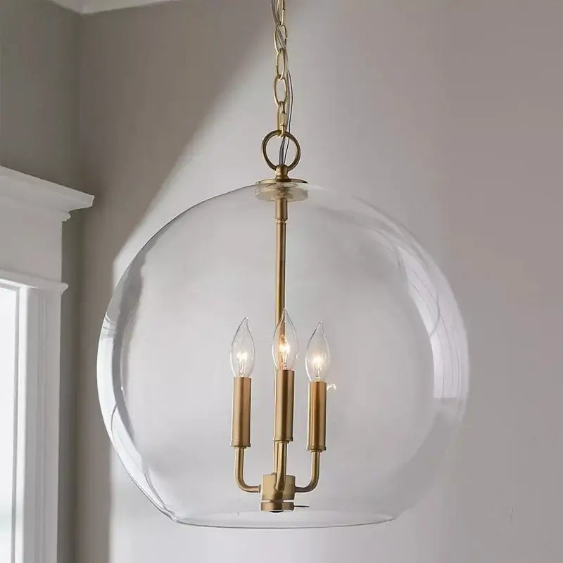 Modern brass glass ball led chandelier featuring a brass-finished spherical pendant with clear glass globe for dining room decorbites glass ball