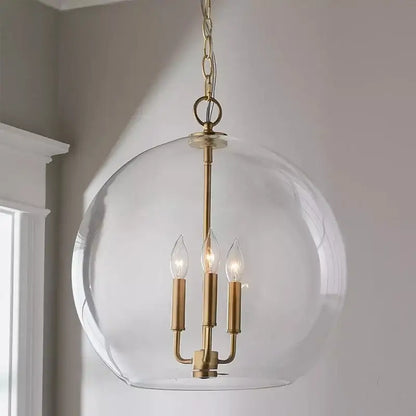 Modern brass glass ball led chandelier featuring a brass-finished spherical pendant with clear glass globe for dining room decorbites glass ball