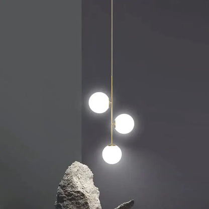 Modern brass glass ball led chandelier with three white glass ball led bulbs suspended by gold-toned rod decorbites glass ball