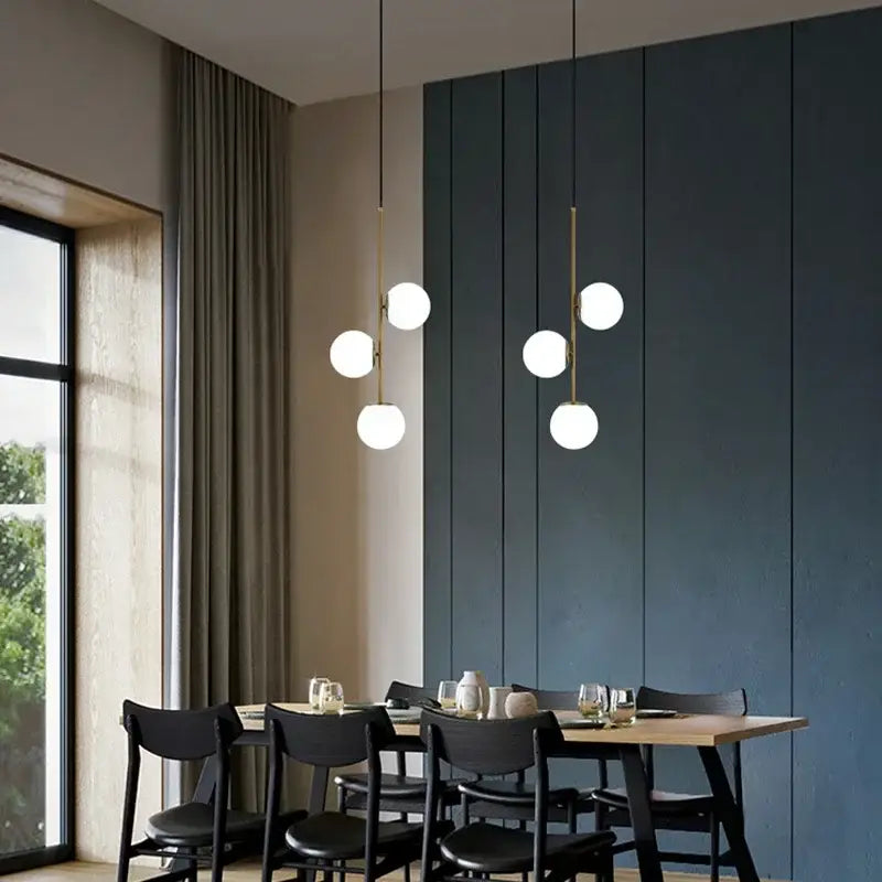 Modern brass glass ball led chandelier with spherical white glass bulbs and gold-toned rods for dining room decorbites glass ball