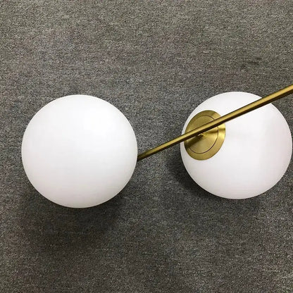 Modern brass glass ball led chandelier with two frosted white glass spheres and polished brass rod for dining room decorbites glass ball