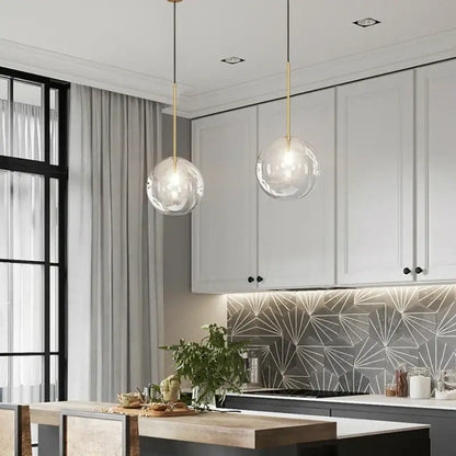 Modern brass glass ball led pendant lamp with clear glass globe and gold-toned metal rods for living room lighting decorbites glass ball