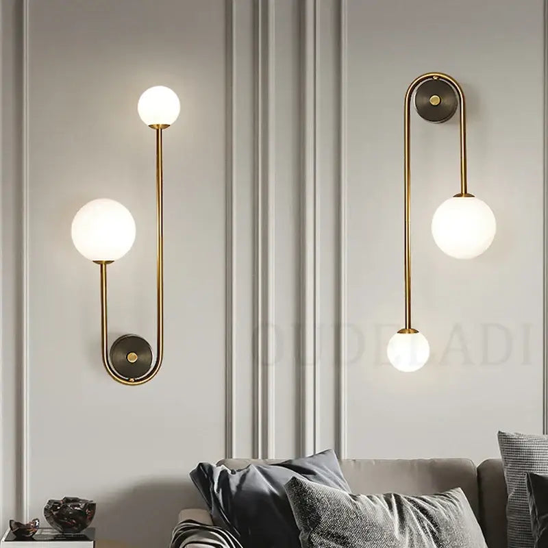 Modern brass glass ball led wall light featuring gold-toned metal arms and frosted glass globe shades for bedroom decorbites wall light