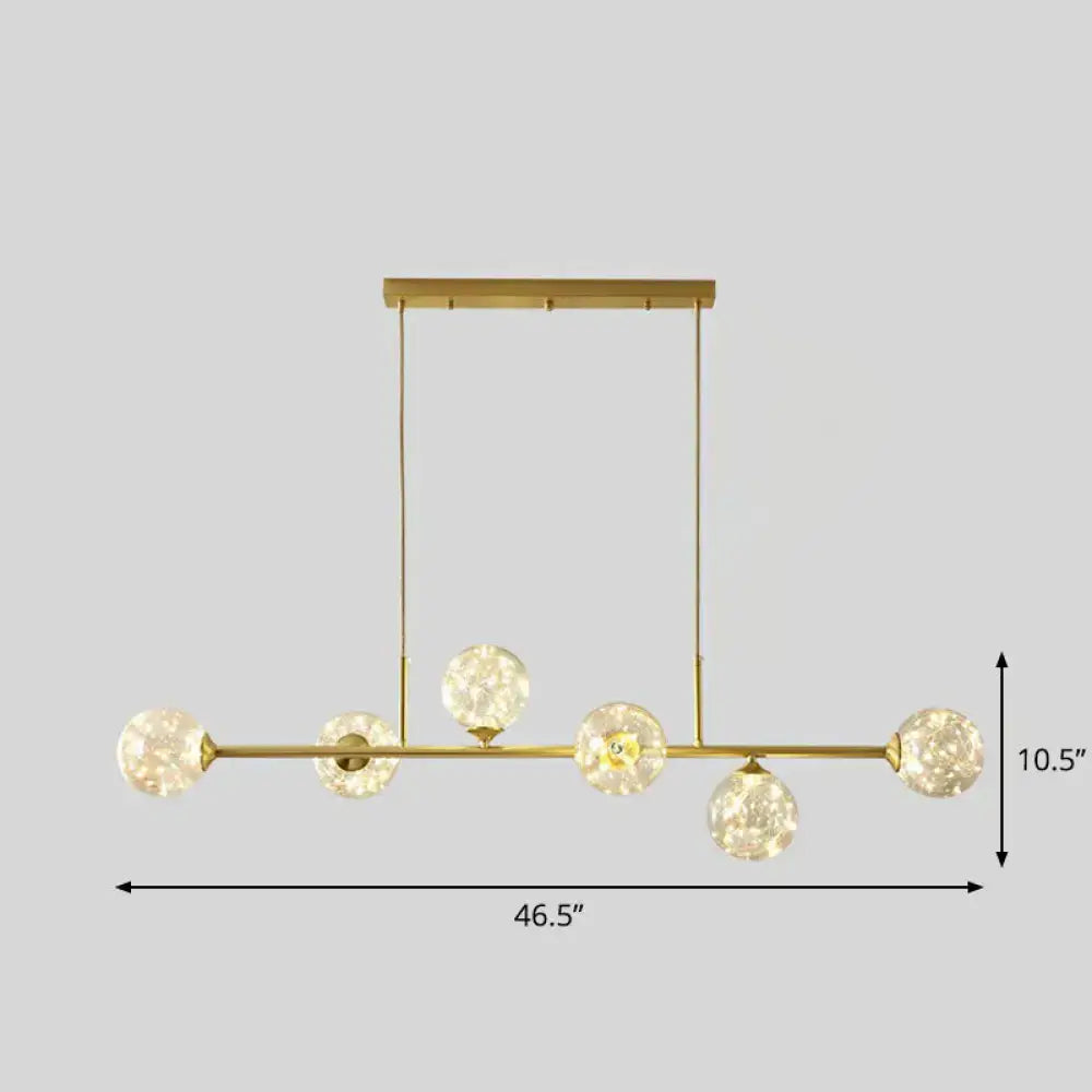 Gold-toned decorbites™ 6-light linear dining room pendant with smoke gray glass ball shades and faceted globe bulbs