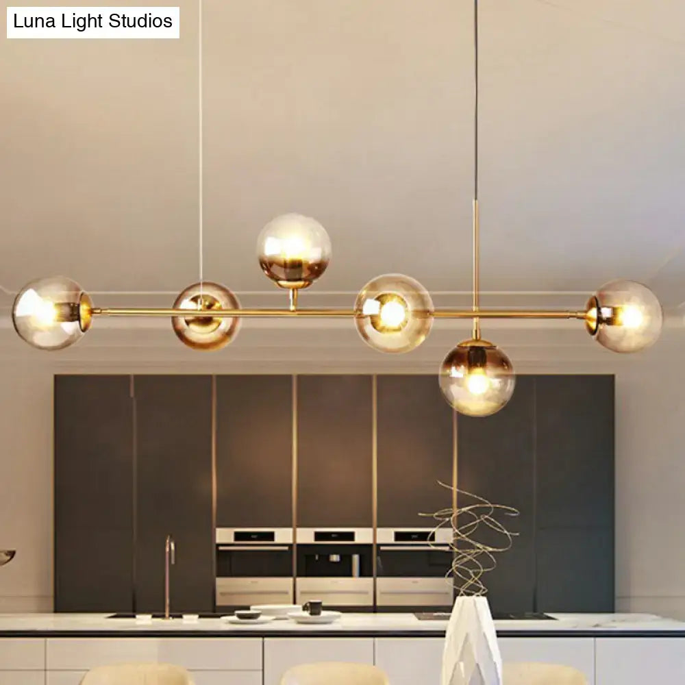 DecorBites 6-light linear dining room pendant with gold-toned brass bar and five smoke gray glass ball shades
