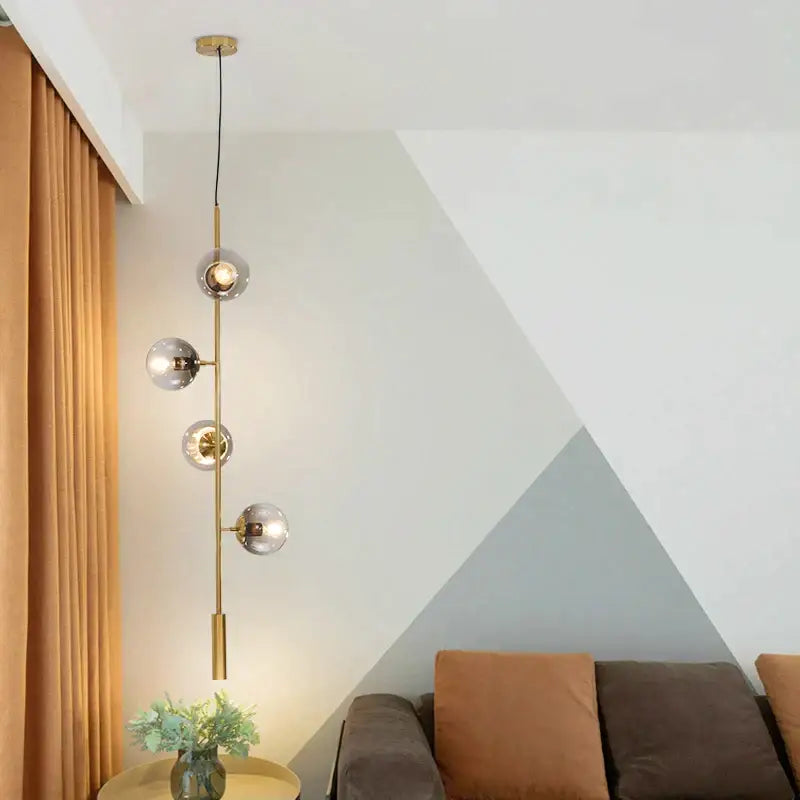 Modern brass pendant light with four spherical glass shades in decorbites glass ball metal design for kitchen bar use