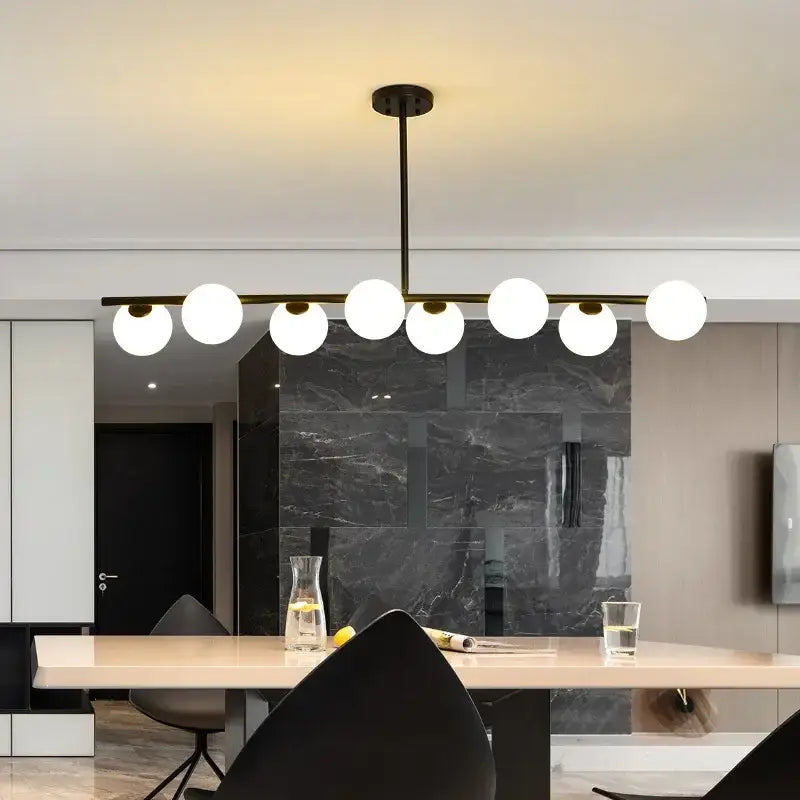 Modern black metal chandelier with seven frosted glass globes is a decorbites glass ball pendant for dining rooms