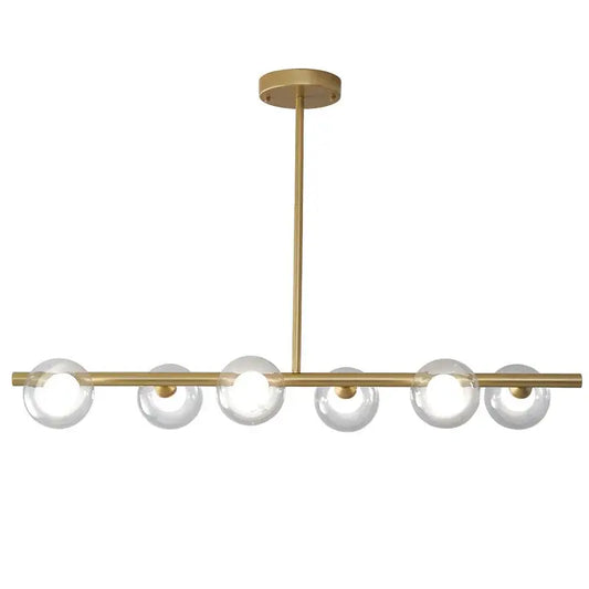 Modern brass glass ball pendant chandelier featuring six clear glass globe bulbs in a linear design for dining room decorbites glass ball