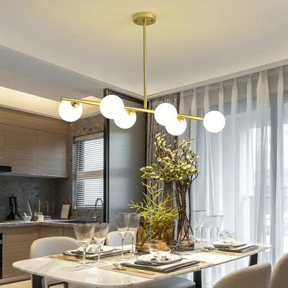 Modern brass glass ball pendant chandelier with five white glass bulbs in gold tone perfect for dining room decorbites glass ball