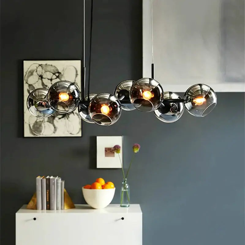 Modern black metal pendant lights with multiple warm glass ball globes for elegant kitchen decorbites glass ball pendant