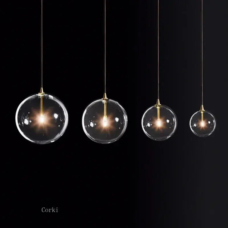 Modern brass glass ball pendant light with clear glass globe and warm glowing bulbs for kitchen decorbites glass ball pendant