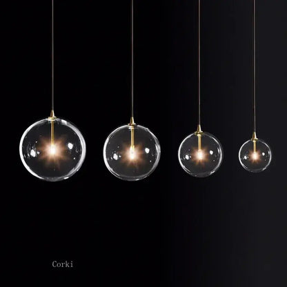 Modern brass glass ball pendant light with clear glass globe and warm glowing bulbs for kitchen decorbites glass ball pendant