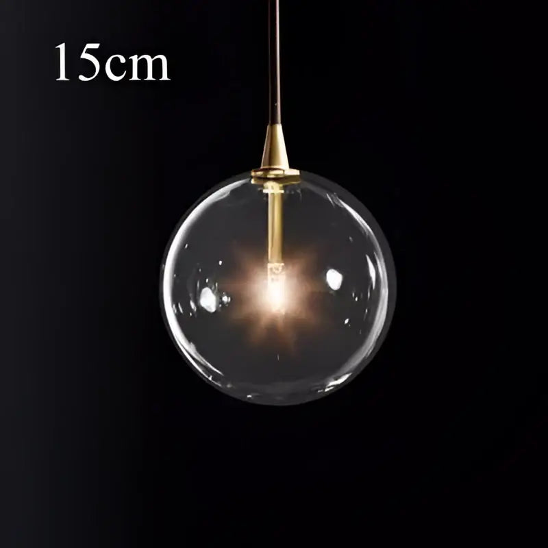 Modern brass glass ball pendant light with a clear glass globe and brass fixture for kitchen decorbites pendant light