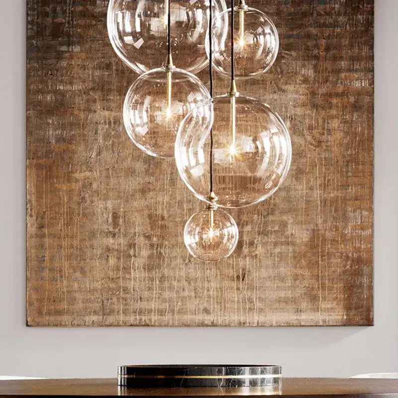 Modern brass glass ball pendant light featuring a clear glass globe with brass accents for kitchen decorbites decorbites glass ball pendant