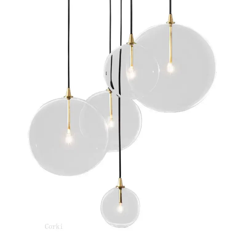Modern brass glass ball pendant light with gold-toned metal accents and black cords for kitchen decorbites glass ball lighting