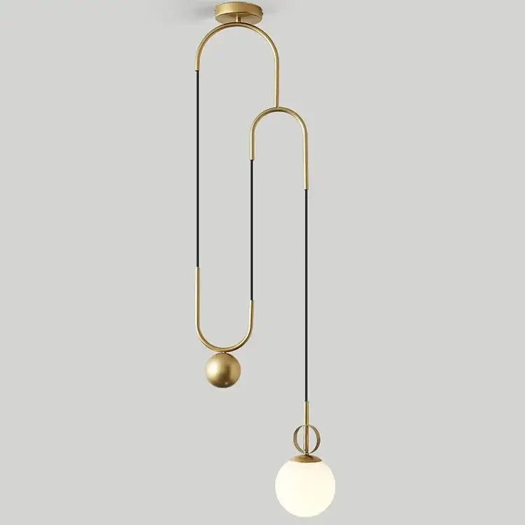 Modern brass glass ball pulley pendant light with sleek curved metal arms and frosted glass globe for dining room decorbites