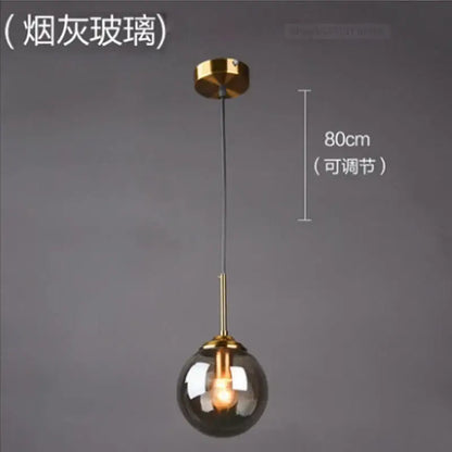 Modern brass glass ball wall lamps featuring a smoky glass globe and polished brass hardware for bedroom decorbites glass ball