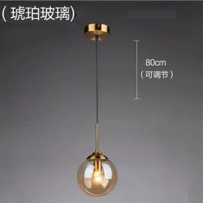 Modern brass glass ball wall lamp featuring a warm amber glass globe with polished brass hardware for bedroom decorbites glass ball