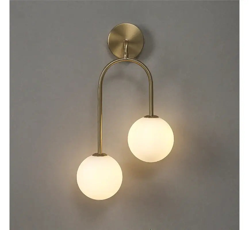 Modern brass glass ball wall lamps featuring two frosted glass globes for bedroom sconce lighting decorbites glass ball