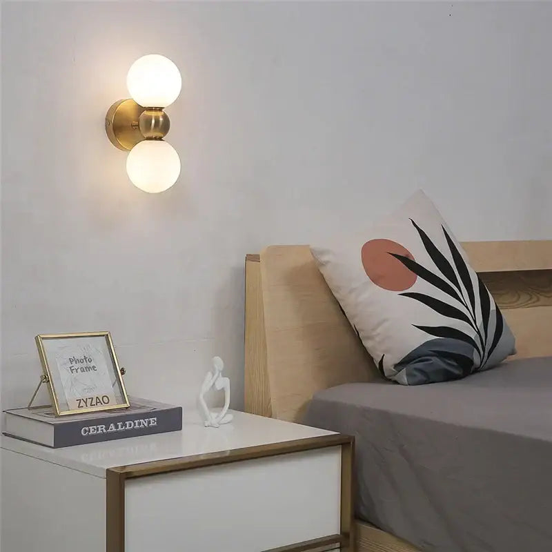 Modern brass glass ball wall lamps with gold-toned wall sconce and two frosted glass globe bulbs for bedroom decorbites wall lamps