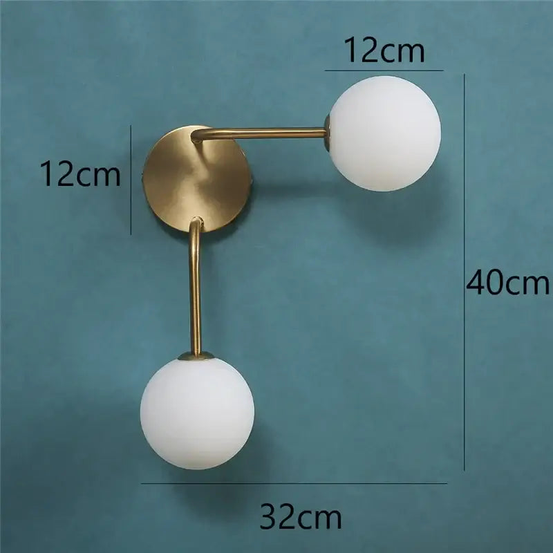 Modern brass glass ball wall lamp with two frosted white spherical shades ideal for bedroom sconce lighting decorbites wall lamps