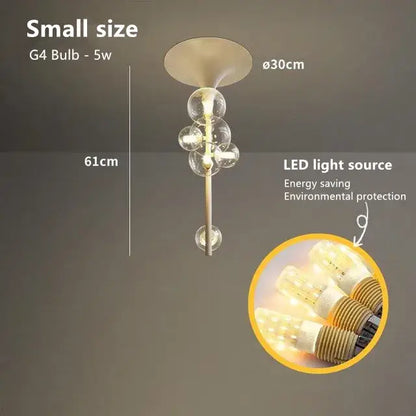 Modern brass glass bubble pendant light with sleek metallic finish and five clear glass globe bulbs in vertical cascade