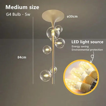 Modern brass glass bubble pendant light with five clear glass globe bulbs and a flared top fixture for dining room decor
