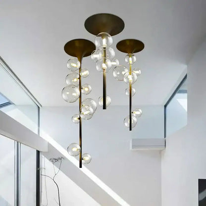 Modern brass glass bubble pendant light with cascading clear glass spheres and exposed bulbs for dining room decorbites pendant light