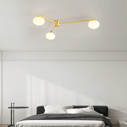 Modern brass glass ceiling lamp with frosted globes featuring gold-toned brass glass decorbites brass glass design