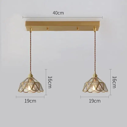 Modern brass pendant lights with geometric faceted glass shades and twisted copper led cords for dining room use