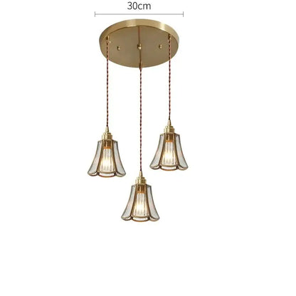 Gold-toned modern pendant lights with three fluted glass shades and twisted copper chains for dining room lighting copper led pendant