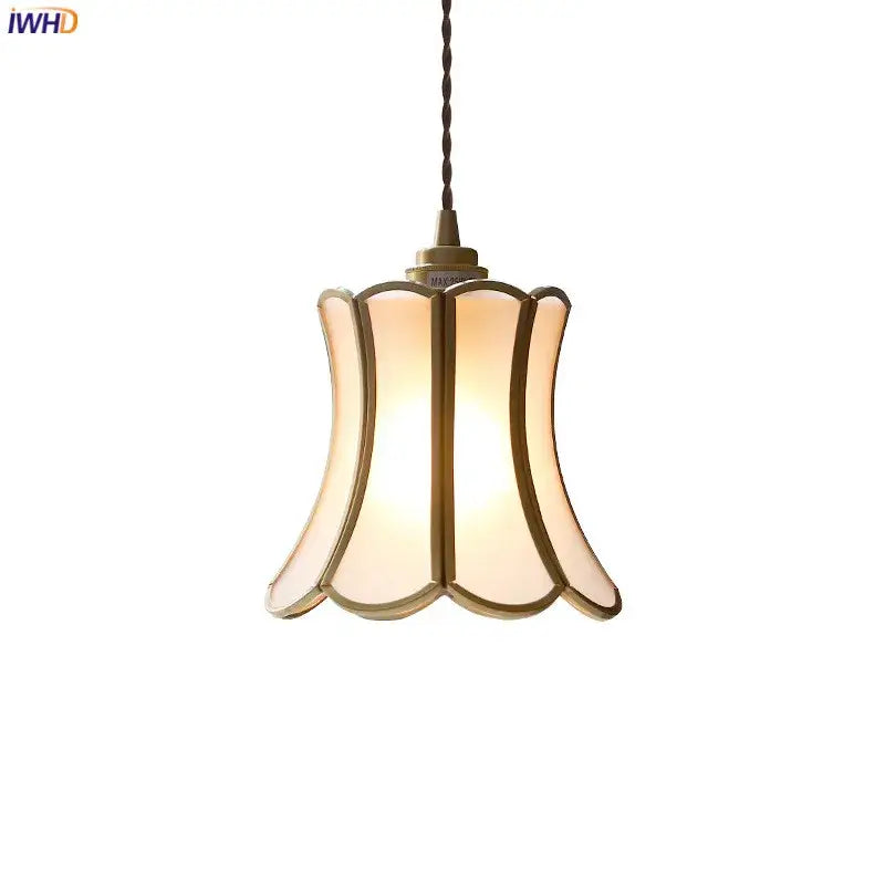 A warm-toned modern brass glass copper led pendant light with bell shape for dining room lighting