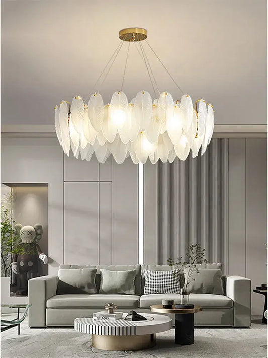 Modern brass glass feather chandelier with translucent leaf-shaped panels in circular design for dining room lighting