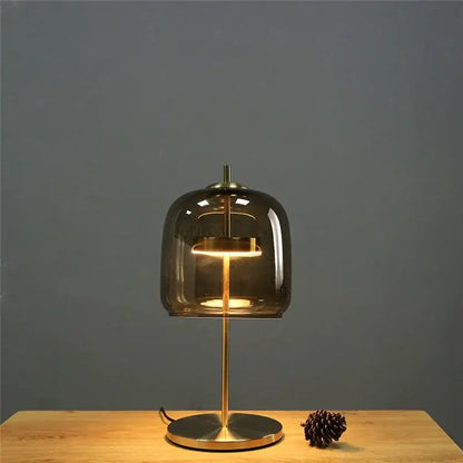 A modern brass glass lampshade led table lamp with smoked glass dome and brass base for bedroom decor