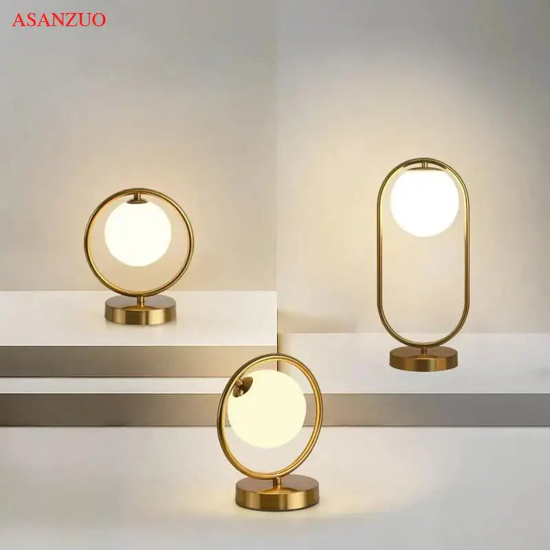 Modern brass glass led table lamp with gold finished circular frames and glowing orbs for bedroom reading desk decorbites brass glass